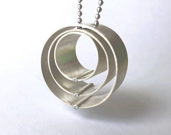 Modern Brushed Finished Sterling silver and diamond pendant, "Family Circle"