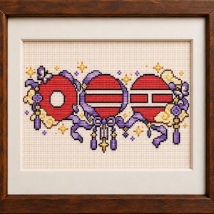 May include: A framed cross-stitch embroidery featuring three circular red shapes with white horizontal stripes, accented by purple ribbons, tassels, and yellow star motifs on a light beige fabric background, all enclosed in a dark brown wooden frame.