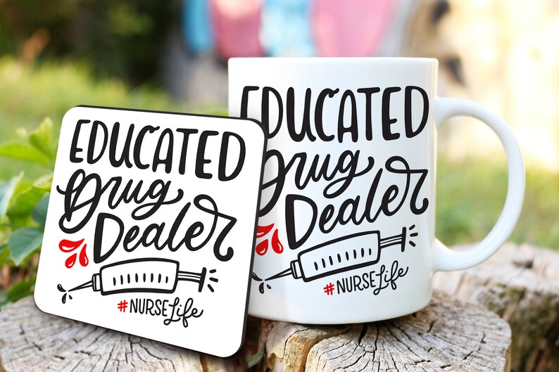 May include: A white ceramic mug and coaster set with the text "EDUCATED Drug Dealer" in black script. The design includes a syringe graphic and the hashtag "#NURSE Life" in red and black. The items are displayed on a wooden surface.