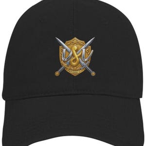 May include: A black baseball cap featuring a central graphic of a gold shield with two crossed silver swords. The letters USI are displayed in a metallic silver font over the shield, with the text Proverbs 27:17 inscribed at the bottom.