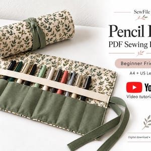 May include: A fabric pencil roll featuring a cream background with a green leaf pattern and a solid olive green pocket section. The roll is secured with matching olive green fabric ties. Text includes SewFile, Pencil Roll, PDF Sewing Pattern, Beginner Friendly, A4 + US Letter, YouTube, and Video tutorial included.
