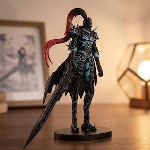 May include: A standing action figure of a warrior clad in black armor with light blue accents. The figure features a long, flowing red and black ponytail, spiked shoulder pauldrons, and holds a large, jagged black sword pointing toward the base.