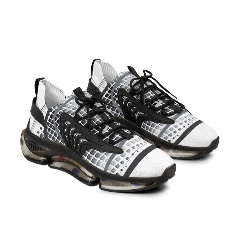 May include: A pair of athletic trainers featuring a white and grey grid pattern on the upper, black lace-up closures, and black structural overlays. The shoes have a thick, translucent, and black segmented sole unit with visible internal cushioning.
