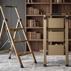 May include: A three-step folding ladder with a metallic gold finish and black accents. The ladder is shown in two positions: one fully extended for use and one folded flat for storage, featuring a top handle and wide, horizontal steps.