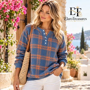 May include: A blue and orange plaid long-sleeve sweater featuring a henley neckline with four white buttons, paired with white pants and a woven straw tote bag. The image includes the text logo ET ElaroTreasures in the upper right corner.