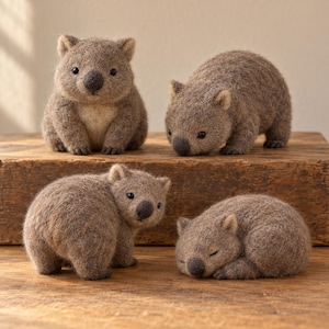 May include: Four needle-felted wombat figurines made of textured brown wool. One sits upright, one stands facing forward, one looks back over its shoulder, and one lies down with eyes closed. Each figure features small ears, a dark nose, and black eyes.