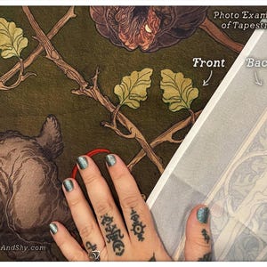 May include: A close-up of a tapestry with a green background and a floral design. The tapestry is being held by a hand with tattoos. The text "Photo Example of Tapestries" is visible at the top of the image. The text "Front" and "Back" are visible at the top right of the image.