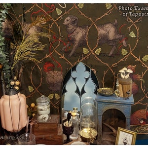 May include: A tapestry with a green background and a repeating pattern of vines and leaves. The tapestry features a ram, a bag, and mushrooms. The tapestry is hanging on a wall with a variety of decorative objects in front of it.