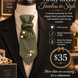 May include: An army green necktie with a textured grid pattern, featuring a knotted design, two round white pearl accents, and a gold-toned metal brooch shaped like the word love with a small flower detail, displayed on a mannequin torso.
