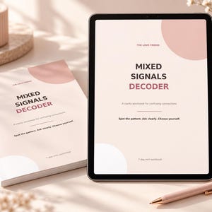 May include: A physical workbook and a digital tablet displaying the same cover design titled Mixed Signals Decoder by The Love Friend. The cover features a pale pink background with dark text, a pink circle graphic, and a light pink pen nearby.