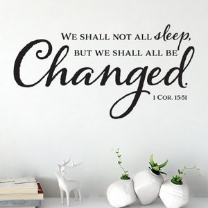 May include: Black and white wall decal with the quote "We shall not all sleep, but we shall all be changed. 1 Cor. 15:51".