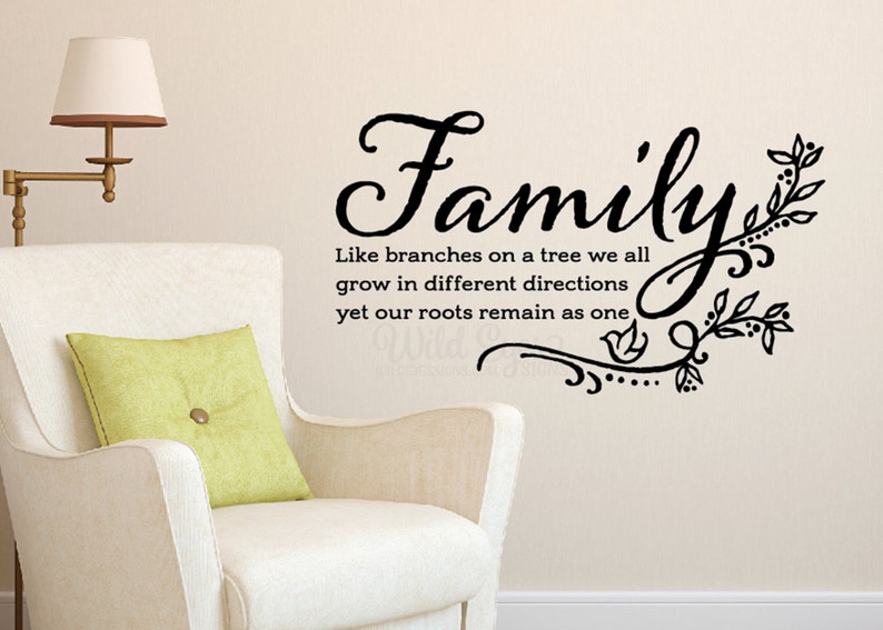 May include: Black and white wall decal with the text "Family" in a decorative font. The text is accompanied by a stylized tree branch design with leaves and a small bird.