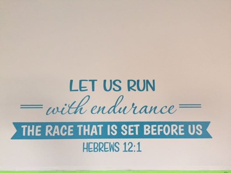 May include: A blue and white motivational quote on a white wall. The quote reads "Let us run with endurance - the race that is set before us - Hebrews 12:1".