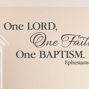 May include: A wall decal with the text "One LORD, One Faith, One BAPTISM. Ephesians 4:5" in a gray font. The text is in a decorative font with a cursive style.