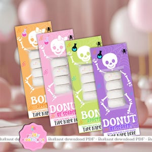 May include: Four colorful Halloween-themed treat packages. Each package features a skeleton design with a skull and bones, holding a stack of donuts. The packages are orange, pink, green, and purple, with text that reads "BO APPETIT" and "DONUT BE SCARED!"