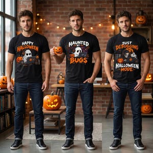 May include: Three black t-shirts featuring Halloween-themed graphics. The left shirt says Happy Halloween with a ghost at a laptop. The centre shirt says Haunted by Bugs with a ghost at a laptop. The right shirt says Just Debugging Halloween Mode.