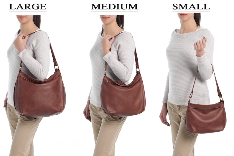 May include: A brown leather hobo bag shown in three sizes labeled LARGE, MEDIUM, and SMALL. The bag features a slouchy, rounded silhouette, a single shoulder strap attached with metal rings, and a top zipper closure. The leather has a smooth finish.