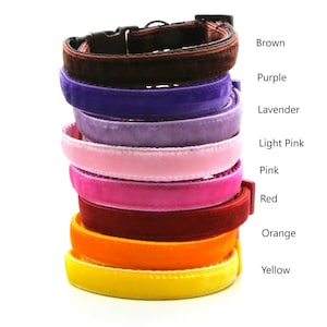 May include: A stack of nine velvet cat collars in various colors, including brown, purple, lavender, light pink, pink, red, orange, and yellow.