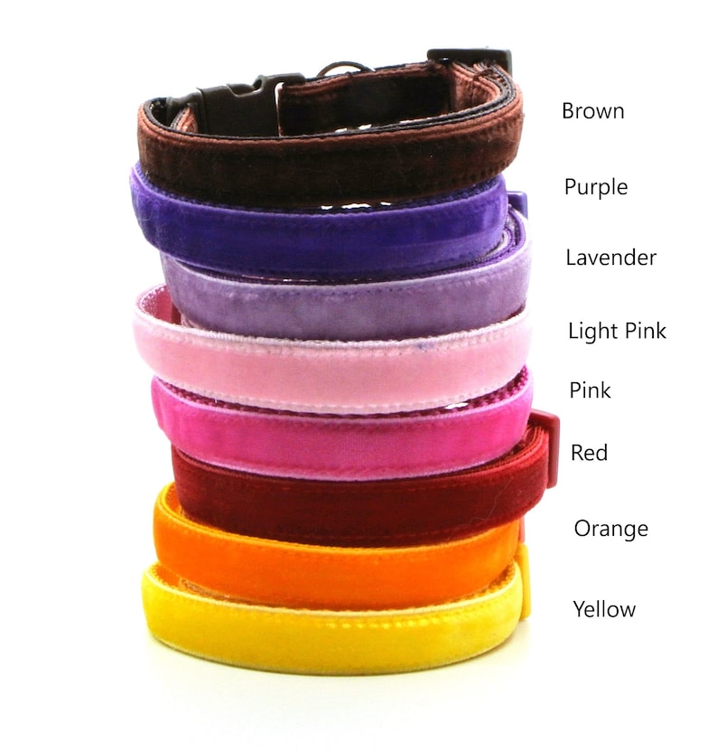 May include: A stack of nine velvet cat collars in various colors, including brown, purple, lavender, light pink, pink, red, orange, and yellow.