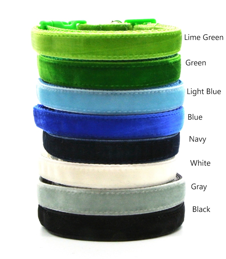 May include: A stack of eight velvet cat collars in various colors, including lime green, green, light blue, blue, navy, white, gray, and black.