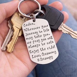 May include: A silver rectangular keychain with the text "Caden. Wherever your Journey in life may take you, we pray you will always be safe. Enjoy the ride! Love, Grammy & Grampy." Includes keys.