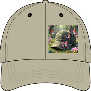 May include: A solid beige baseball cap featuring a square graphic print on the front panel. The graphic depicts a camouflage baseball cap resting in a grassy field with pink flowers and three colorful butterflies with rainbow-patterned wings.