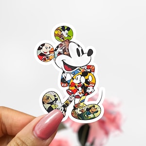 May include: A colorful sticker featuring Mickey Mouse made up of various images of Mickey Mouse. The sticker is white with a black outline and features Mickey Mouse in a red, yellow, and blue shirt.