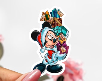 May include: Mickey Mouse dressed as Santa Claus holding a stack of wrapped presents. The presents are decorated with festive ribbons and bows. The sticker is white with a red border.