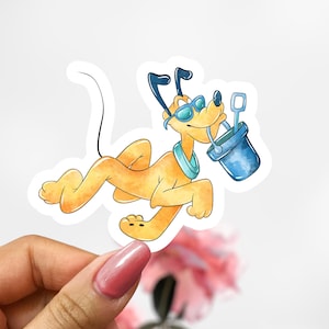 May include: A watercolor sticker featuring a cartoon dog in sunglasses, a blue collar, and a bucket with a shovel. The dog is light orange and is lying down. The bucket and shovel are blue.