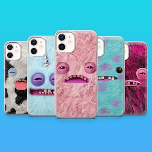 May include: Five smartphone cases featuring textured, faux-fur surfaces with monster-like faces. The designs include a black and white cow print, a light blue unicorn, a solid pink, a light blue with purple spots, and a dark pink and black pattern.