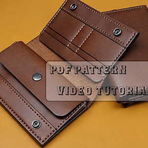May include: A brown leather wallet featuring multiple card slots, a central flap with a snap button closure, and visible stitching. The wallet is displayed open, showing its internal compartments. The text PDF PATTERN VIDEO TUTORIAL is visible.