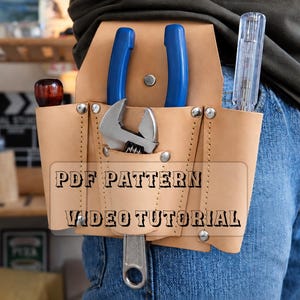 May include: A light tan leather tool pouch worn on a belt, featuring multiple pockets secured with silver-tone metal rivets. The pouch holds blue-handled pliers, an adjustable wrench, and a clear screwdriver. Text reads: PDF PATTERN VIDEO TUTORIAL.