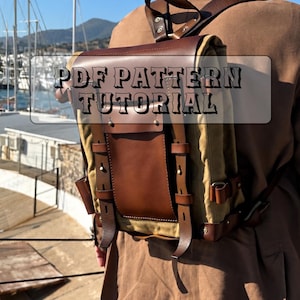 May include: A tan canvas and brown leather backpack featuring a top flap, vertical leather straps with metal rivets, and side adjustment buckles. The text PDF PATTERN TUTORIAL is overlaid on the center of the bag in a dark, stylized font.