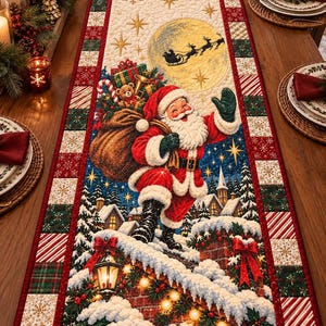 May include: A rectangular quilted table runner featuring a central illustration of Santa Claus carrying a toy sack on a snowy rooftop. The design includes a full moon with a reindeer sleigh silhouette, surrounded by a border of red, green, and white squares.