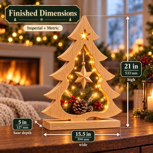 May include: A light wood Christmas tree decoration with a cutout center, illuminated by string lights. It features a hanging star, pinecones, and red berries. Dimensions are 21 inches high, 15.5 inches wide, and 5 inches base depth.