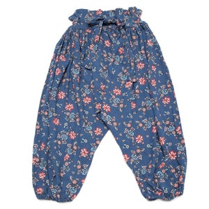 May include: Blue floral print pants with a gathered waist and a tie belt.