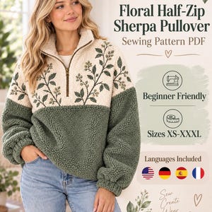 May include: A PDF sewing pattern for a floral half-zip sherpa pullover. The design features a cream-colored upper section with dark green embroidered leaf and berry motifs, and a solid dark green lower section. Includes sizes XS-XXXL.