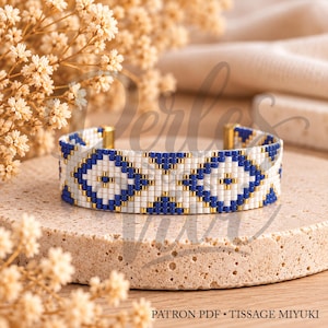 Peut inclure: Un bracelet en perles tissées arborant un motif géométrique blanc, bleu roi et doré métallisé. Le design se compose de losanges et de petits carrés répétés. Le bracelet se termine par des fermoirs en métal doré. Texte : PATRON PDF TISSAGE MIYUKI.