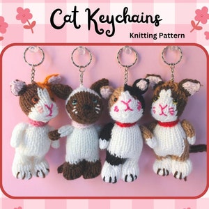 May include: Four knitted cat keychains with different color patterns. The keychains are hanging from silver key rings. The background is a pink and white checkered pattern with flowers.