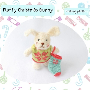 May include: Knitting pattern for a fluffy white Christmas bunny wearing a green sweater with a red snowflake design and holding a green stocking with red trim.