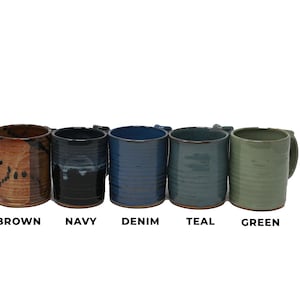 May include: Five ceramic mugs in different colors: brown, navy, denim, teal, and green. Each mug has a unique glaze and texture.