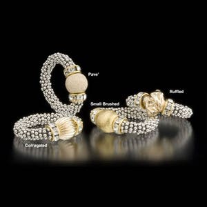 May include: Four silver and gold bracelets with different styles of beads and accents. The bracelets are labeled "Corrugated", "Small Brushed", "Pave", and "Ruffled".