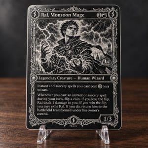 May include: A black and white trading card titled Ral, Monsoon Mage, featuring a human wizard surrounded by lightning. The card text details abilities for instant and sorcery spells, coin flips, and transformation mechanics, with a 1/3 power and toughness.