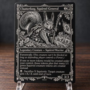 May include: A black and white trading card titled Chatterfang, Squirrel General. The card features an illustration of a squirrel warrior holding a staff, surrounded by smaller squirrels and a flag. Text includes game rules and the power 3/3.