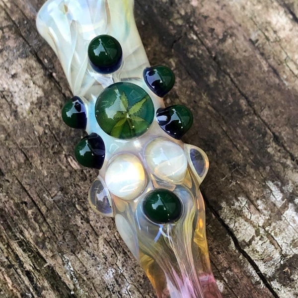 SWEET LEAF Glass pipes is a fumed chillum.  Hand blown leaf Millie with highlights. Color changing.  Flat mouth piece.