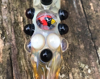 Cardinal Glass pipes is a fumed chillum.  Hand blown Cardinal Millie with Red and white highlights. Color changing.  Flat mouth piece.