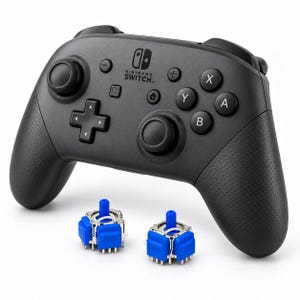 May include: A black Nintendo Switch Pro controller featuring a standard button layout, dual analog sticks, and a directional pad, accompanied by two blue replacement joystick modules with metallic components positioned in the foreground.