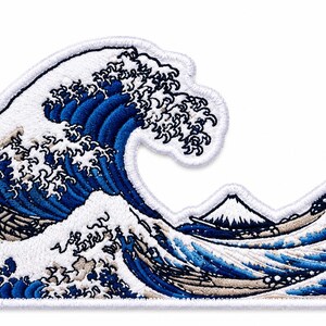 May include: An embroidered patch featuring a large, curling ocean wave in shades of deep blue and white, with a small, snow-capped mountain peak visible in the background. The design is outlined with a thick white border and dense stitching.