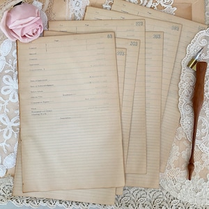 May include: A stack of vintage, lined paper forms with handwritten numbers and headings like "Grantor", "Married", "Instrument", "Consideration", "Date of Instrument", "Date of Acknowledgment", "Before Whom", "Official Title", "Commission Expires", "Filed", "Homestead and Dower", "Greeting Words", and "Description".