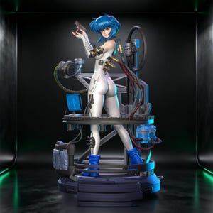 May include: A collectible anime-style figurine of a character with short blue hair, wearing a white bodysuit with mechanical details. The figure stands on a complex circular base featuring various cables, a small computer screen, and blue boots.